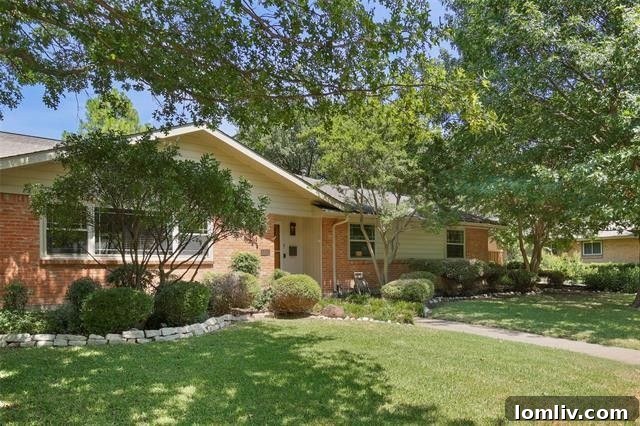 Charming Ranch-style home exterior with lush landscaping and mature trees