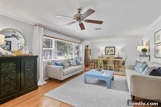 Spacious and bright living room with large windows overlooking the backyard