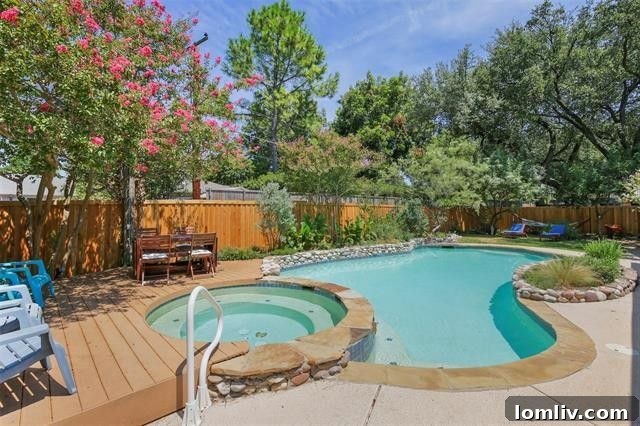 Private backyard oasis with a sparkling swimming pool and towering shade trees