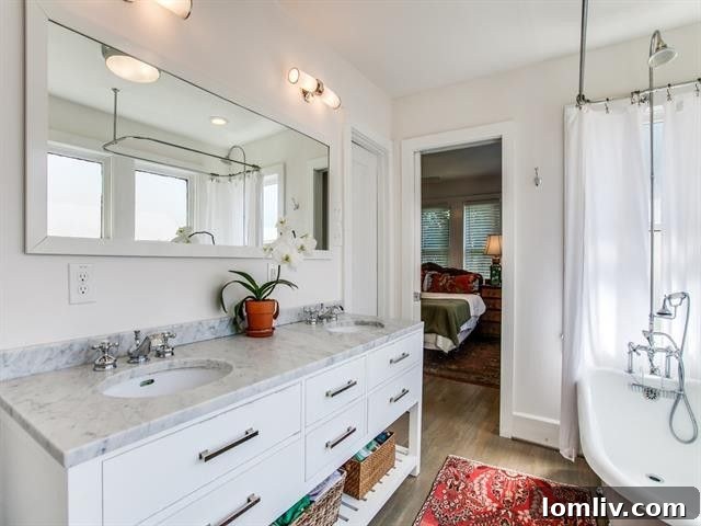 Serene master bathroom with classic claw foot tub and marble vanity