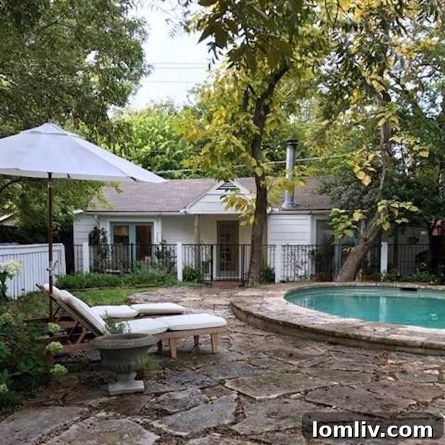 Lush backyard with a sparkling swimming pool, mature trees, and ample green space