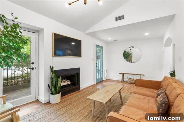 Elegant living room with a cozy wood-burning fireplace and stunning hardwood floors