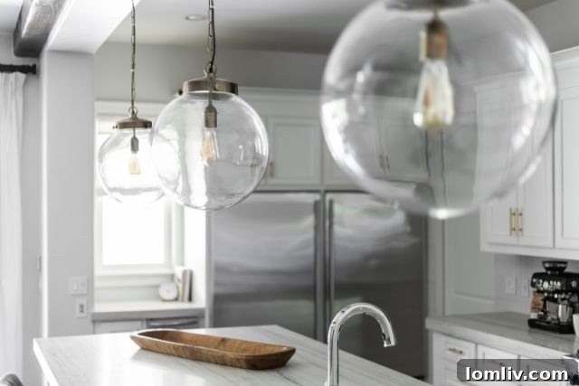 Modern kitchen with two glass globe pendants over island
