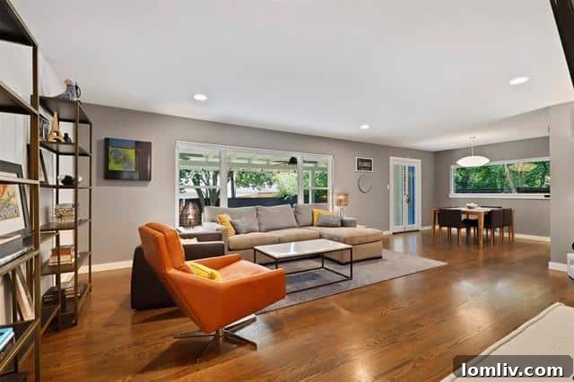 A brightly lit and inviting living room with hardwood floors and an open-concept design.