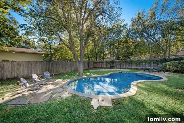 Outdoor living space with a swimming pool and fireplace, perfect for entertaining in Kidd Springs Heights.