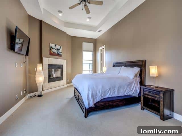 Luxurious master bedroom with a cozy fireplace