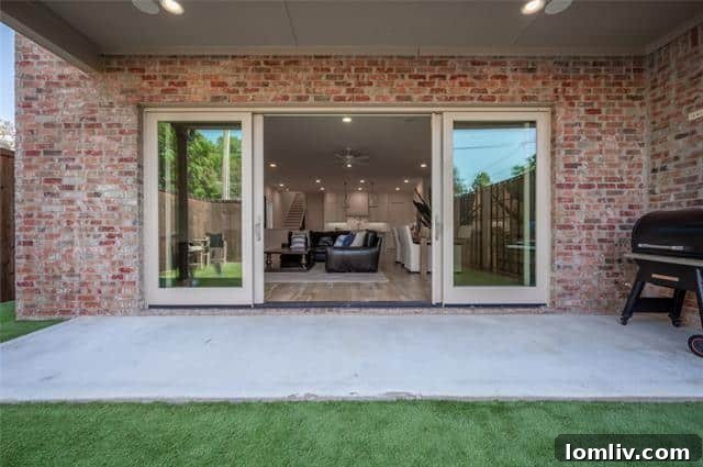 Low-maintenance turf backyard with privacy fence at a modern Dallas duplex