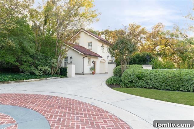 An Italian Renaissance Gem Atop the River Crest 21 Driveway entrance featuring historic Thurber brick