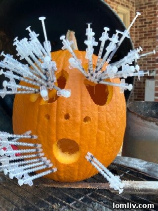 Close-up of a meticulously carved pumpkin face with glowing eyes