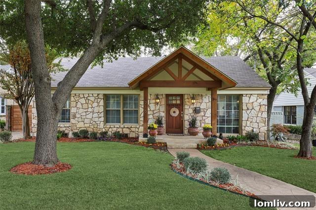 Elegant white cottage exterior with stone accents and a welcoming front porch in Oak Cliff, Dallas
