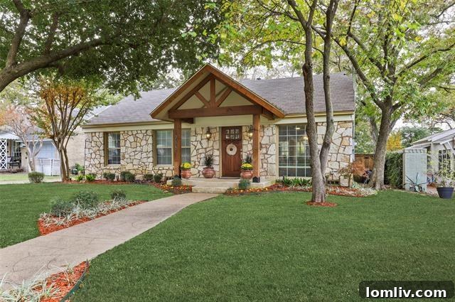 Charming stone cottage exterior with a welcoming red front door and lush green landscaping