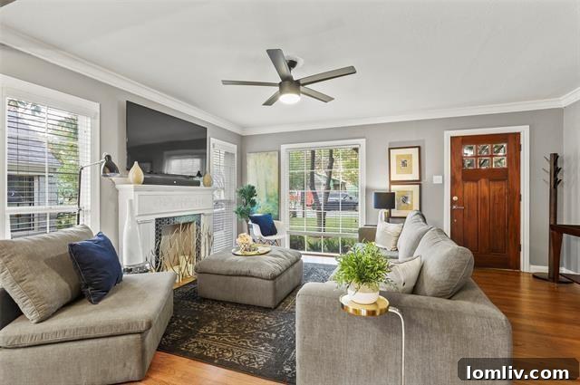 Bright and spacious living room with exposed wooden beams, ample seating, and a view into the kitchen