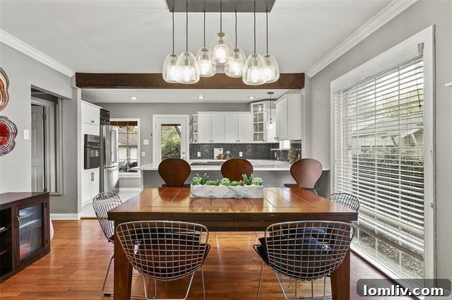 Elegant marble kitchen island with sink and seating, showcasing stylish brass fixtures and ample workspace