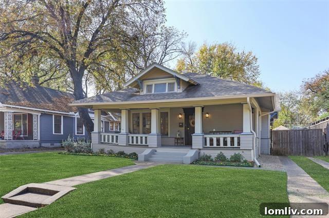 Grand exterior view of a prairie-style home with expansive front porch and lush landscaping in Oak Cliff, Dallas