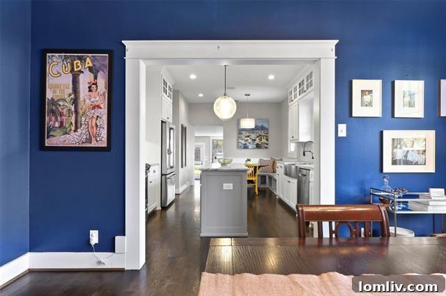 Bright and airy dining area with large windows, seating for six, and access to the modern kitchen