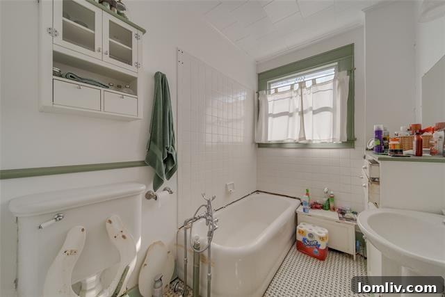 Close-up of vintage corner tub in 3142 College Avenue bathroom