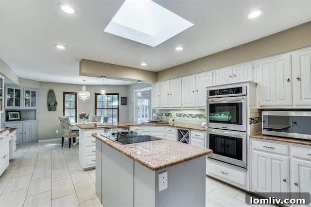 A contemporary kitchen with stainless steel appliances, crisp white cabinetry, and a functional layout that blends style and utility.
