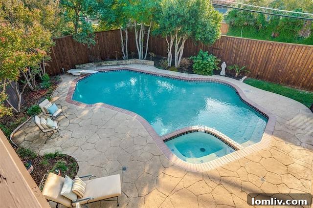 The stunning quartz pool and stamped concrete patio, creating a perfect outdoor entertainment area in the backyard.
