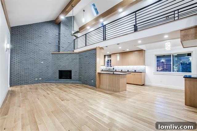 An inviting foyer with a grand floating staircase, showcasing the impressive entry hall and modern design elements of the renovated home.
