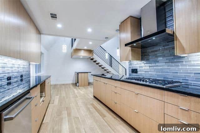 A spacious, light-filled family room with soaring ceilings, a modern fireplace, and large windows overlooking the lush backyard.