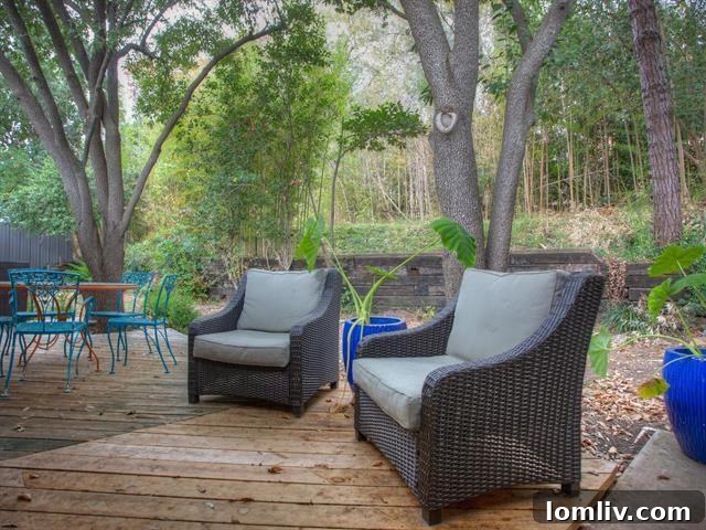 Inviting back deck offering serene views of the expansive yard and mature trees