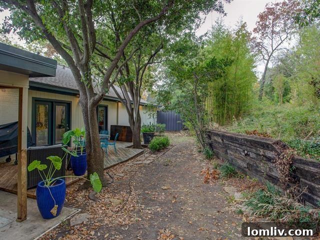 Rear exterior view of the elegant 1960s Ridgmar home with a spacious yard and deck