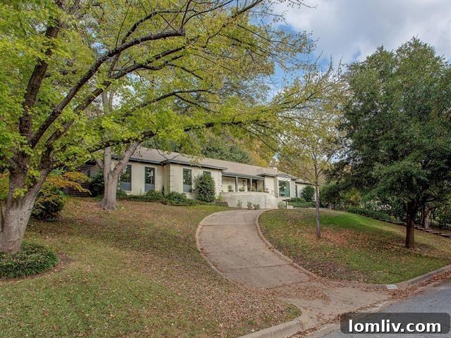 Elegant circular driveway leading to a secluded 1960s Fort Worth Ridgmar residence