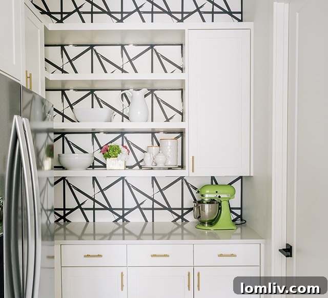 Kitchen space designed by New Leaf featuring an accent wall with stylish wallpaper
