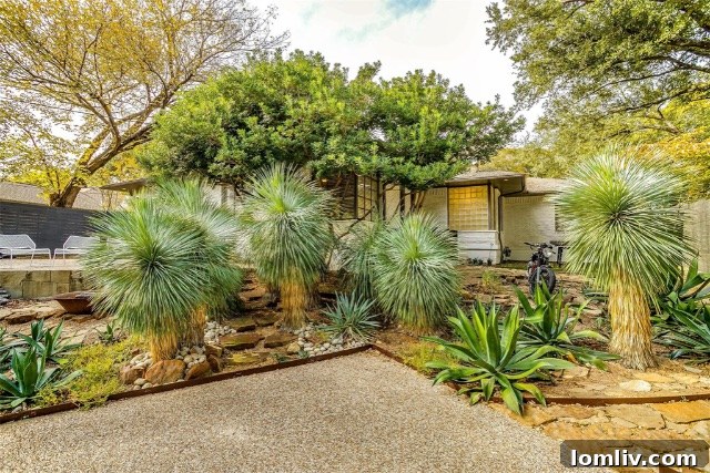 Midcentury Brilliance: A Home That Colors Your World with Joy 3 Lush backyard oasis with flagstone patio and diverse landscaping at 1338 Rainbow Drive