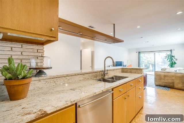 Midcentury Brilliance: A Home That Colors Your World with Joy 8 Beautifully updated mid-century modern kitchen with cork flooring, granite countertops, and honey-toned cabinetry