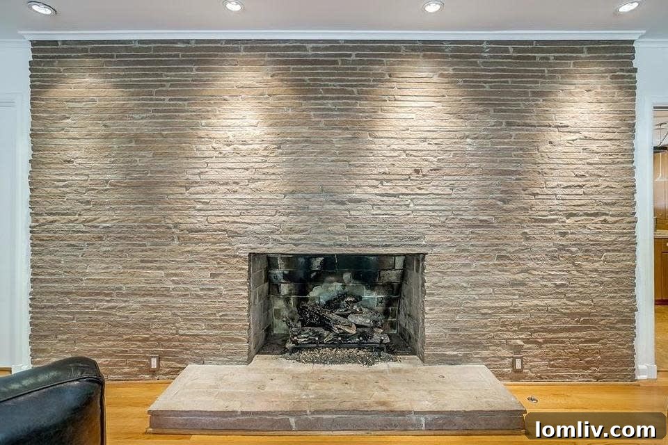 Midcentury Brilliance: A Home That Colors Your World with Joy 9 Iconic stacked Roman brick fireplace serving as a grand focal point in the main living area