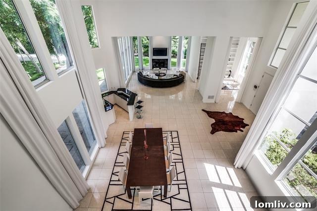 Living room with double-height windows overlooking a nature preserve