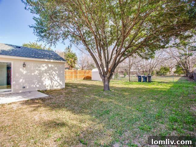 Spacious fenced backyard with mature trees in Fort Worth home