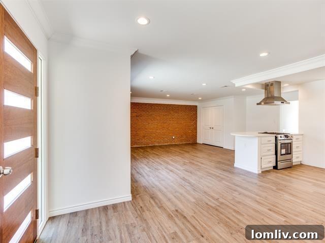 Bright open-concept living room with exposed brick wall in Fort Worth