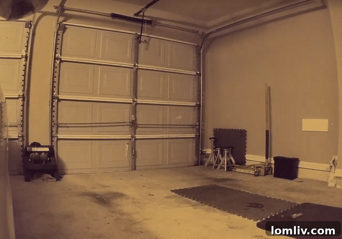 Before image of a worn concrete garage floor with stains and cracks, awaiting transformation.