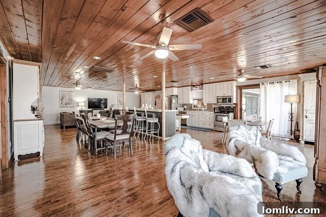 Aerial view showcasing the extensive lakefront of 9432 Heron Drive, including multiple structures and private dock.