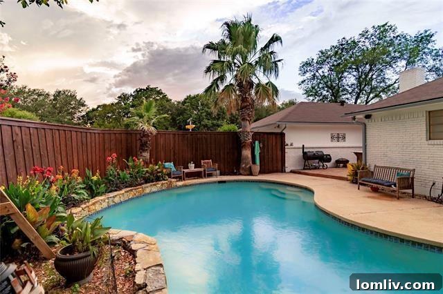 Lake Highlands Radiant Renewal 3 Private backyard oasis with a sparkling pool and lush landscaping in a Lake Highlands home, ideal for summer entertaining.