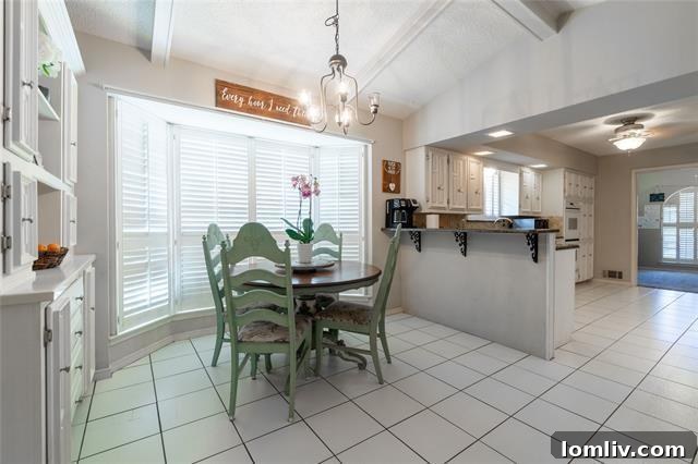 Lake Highlands Radiant Renewal 6 Spacious granite kitchen with white cabinetry, stainless steel appliances, and a sunny bay window breakfast nook.