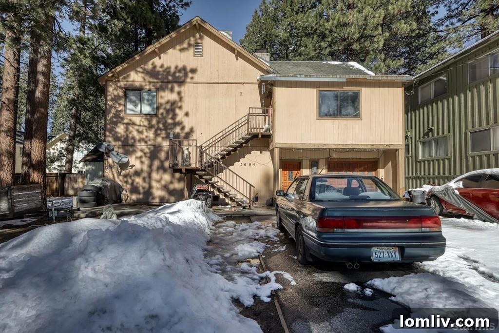 Exterior view of a duplex property in South Lake Tahoe, featuring a rustic design with an image file name placeholder