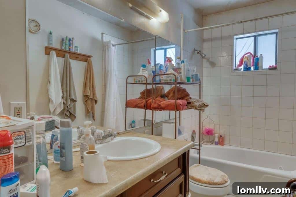 Bedroom with a bed frame and mattress, but lacking proper bedding or tidiness