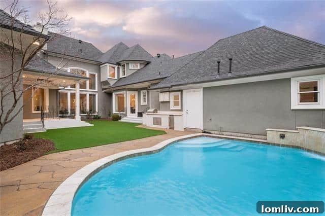 Backyard oasis with sparkling pool and outdoor kitchen overlooking golf course