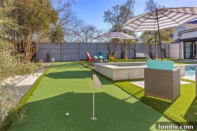 Expansive outdoor patio with fireplace, seating, and views of the pool