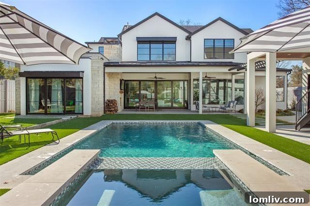 Lush backyard with heated pool, jacuzzi, and dedicated lounge areas