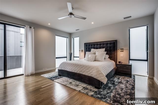 master bedroom with hardwood floors and private balcony access