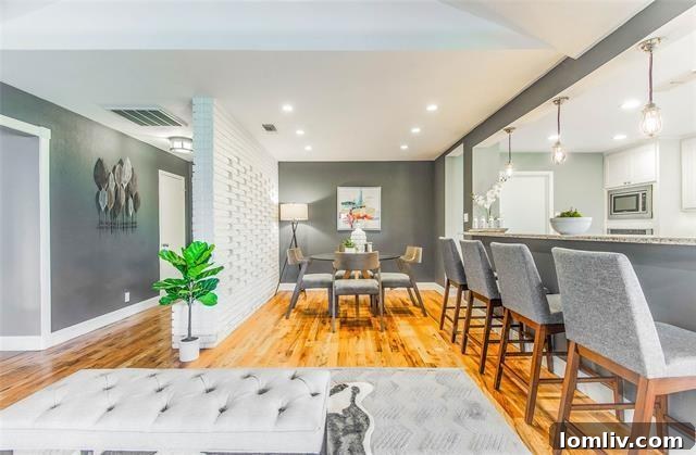 Spacious living room with Midcentury Modern design, exposed brick, and abundant natural light