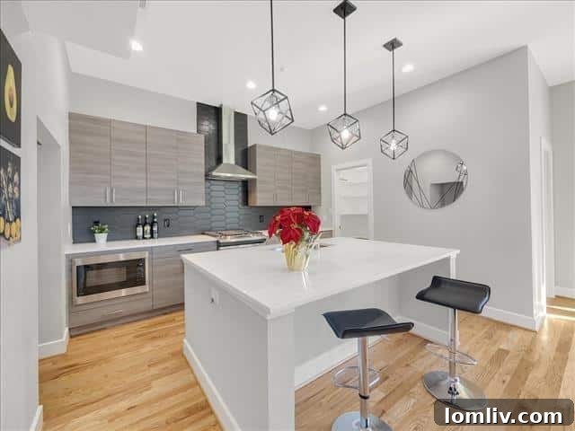 Contemporary kitchen with quartz countertops, custom cabinetry, and high-end stainless steel appliances.