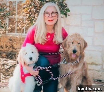 Smiling woman with two Goldendoodle dogs
