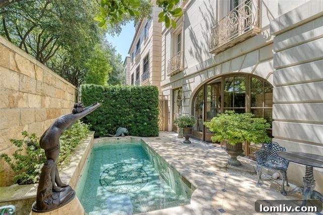 The tranquil private marble lap pool area within a luxury Dallas townhouse, offering a secluded outdoor retreat
