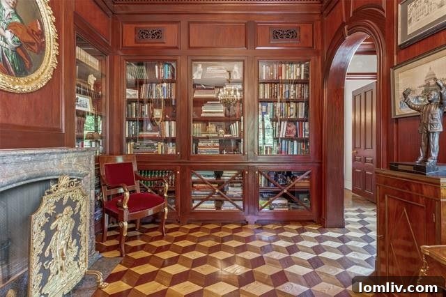 A stunning mahogany-paneled library featuring built-in bookshelves, a cozy fireplace with a stone mantel, and a separate bar area