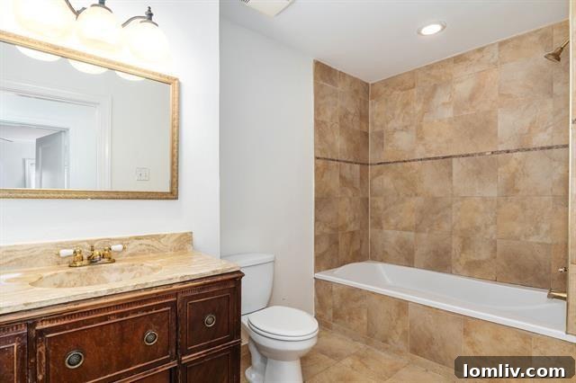 A glimpse into the updated kitchen with charming glass-front cabinets and original hardwood floors, blending old and new.